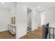 Bright hallway with hardwood floors, leading to various rooms with an elegant console table and artwork at 52 25Th Nw St, Atlanta, GA 30309