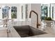 Modern kitchen featuring marble countertops, stainless steel sink, and stylish gold faucet at 52 25Th Nw St, Atlanta, GA 30309