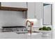 Modern kitchen showcasing white subway tile backsplash, stainless steel range, and a marble countertop island at 52 25Th Nw St, Atlanta, GA 30309