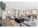 Bright living room featuring hardwood floors, recessed lighting, fireplace, and open floor plan to kitchen and dining area at 52 25Th Nw St, Atlanta, GA 30309