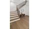 Elegant staircase featuring wood treads, black iron railings, and a cozy bench with decorative mirror at 52 25Th Nw St, Atlanta, GA 30309