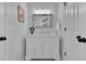 Bathroom featuring a white vanity with a marble countertop, framed mirror, and modern lighting fixtures at 577 Alexander Farms Sw Vw, Marietta, GA 30064