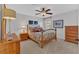 Bedroom featuring a ceiling fan and a bed with floral bedding, along with wood furnishings at 577 Alexander Farms Sw Vw, Marietta, GA 30064