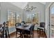 Formal dining room with a chandelier, large windows, and hardwood floors at 577 Alexander Farms Sw Vw, Marietta, GA 30064