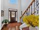 Elegant foyer with hardwood floors, staircase, stained glass front door and yellow flowers at 577 Alexander Farms Sw Vw, Marietta, GA 30064