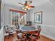 Bright game room features a ceiling fan, hardwood floors, and a round table surrounded by six rolling chairs at 577 Alexander Farms Sw Vw, Marietta, GA 30064