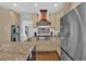 Modern kitchen with stainless steel appliances and custom range hood at 577 Alexander Farms Sw Vw, Marietta, GA 30064