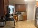 The well-equipped kitchen features wood cabinets, stainless steel appliances, and granite countertops at 72 Grayson New Hope Rd, Grayson, GA 30017