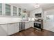 Modern kitchen boasts white cabinets, stainless appliances, and a farmhouse sink beneath bright windows at 1147 Longshore Dr, Decatur, GA 30032