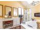 Bright bathroom featuring a shower, tub, chandelier, and vanity with framed mirrors at 4210 Gatewood Ln, Peachtree Corners, GA 30097