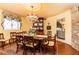 Cozy dining room features a wood table set on an oriental rug with stone accent walls and decorative lighting fixture at 4210 Gatewood Ln, Peachtree Corners, GA 30097