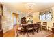 Bright dining room with stone walls, decorative chandelier, window and furniture at 4210 Gatewood Ln, Peachtree Corners, GA 30097