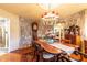 Inviting dining room with natural stone walls, hardwood floors, and classic wooden furniture at 4210 Gatewood Ln, Peachtree Corners, GA 30097