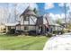 Beautiful Tudor-style home with a unique turret, stone accents, and lush landscaping at 4210 Gatewood Ln, Peachtree Corners, GA 30097
