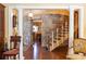 Elegant foyer featuring a stone accent wall and staircase with classic columns at 4210 Gatewood Ln, Peachtree Corners, GA 30097