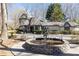 Charming home with a circular driveway, water fountain, and manicured landscaping at 4210 Gatewood Ln, Peachtree Corners, GA 30097