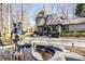 Stunning home featuring a water fountain, brick walkway, and beautiful architectural details at 4210 Gatewood Ln, Peachtree Corners, GA 30097