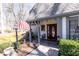 Welcoming front porch with a cozy seating area and stone accents, providing a charming entrance to the home at 4210 Gatewood Ln, Peachtree Corners, GA 30097