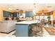 Kitchen featuring island with seating, blue cabinetry, and tile flooring at 4210 Gatewood Ln, Peachtree Corners, GA 30097