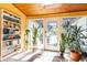 Sunroom showcasing large windows, skylight, tiled floor, and many plants at 4210 Gatewood Ln, Peachtree Corners, GA 30097