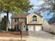 Charming two-story home features a brick facade, attached two-car garage, and well-maintained front yard at 4369 Estate St, South Fulton, GA 30349