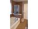 Relaxing bathroom featuring a soaking tub with a tile surround and glass shower at 4402 Alysheba Dr, Fairburn, GA 30213