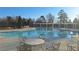 Sparkling community swimming pool with ample seating and shaded areas, ideal for relaxation and recreation at 4402 Alysheba Dr, Fairburn, GA 30213