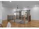 A lovely loft area featuring modern chandelier, barn doors, hardwood floors, and easy access to other rooms at 5760 Pearson Rd, Powder Springs, GA 30127