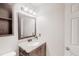 Cozy bathroom featuring wooden vanity, a framed mirror and ample lighting at 1284 To Lani Path, Stone Mountain, GA 30083