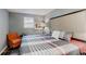 Cozy bedroom showcasing a stylish plaid comforter, natural lighting, and comfortable armchair at 1284 To Lani Path, Stone Mountain, GA 30083