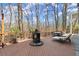 Large wooden deck with a fire pit, dining table, grill and lounge furniture at 1750 Branch Valley Dr, Roswell, GA 30076