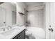 A well-lit bathroom with a gray vanity, a large mirror and shower over tub at 1923 Skyfall Ne Cir, Atlanta, GA 30319