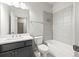 Bathroom featuring gray vanity, large mirror, shower and tub with gray tile at 1923 Skyfall Ne Cir, Atlanta, GA 30319