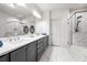 Elegant bathroom featuring double vanity, marble floors, and a glass shower at 1923 Skyfall Ne Cir, Atlanta, GA 30319