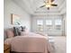 Charming bedroom with a ceiling fan, tray ceiling, and view of the neighborhood at 1923 Skyfall Ne Cir, Atlanta, GA 30319