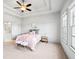 Light-filled bedroom with a ceiling fan, tray ceilings and ensuite bath at 1923 Skyfall Ne Cir, Atlanta, GA 30319