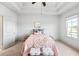 Cozy bedroom featuring a ceiling fan, tray ceilings and neutral decor at 1923 Skyfall Ne Cir, Atlanta, GA 30319