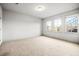 Bedroom featuring three windows for natural light and neutral carpet flooring at 1923 Skyfall Ne Cir, Atlanta, GA 30319