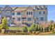 Elegant townhome exterior featuring brick and siding, a well-manicured lawn, and black wrought iron fencing at 1923 Skyfall Ne Cir, Atlanta, GA 30319