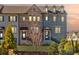 Elegant townhome exterior featuring mixed materials, a cozy entrance, and professionally maintained landscaping at 1923 Skyfall Ne Cir, Atlanta, GA 30319