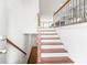 Inviting foyer featuring wooden stairs, white walls, and elegant railing, leading to the main living area at 1923 Skyfall Ne Cir, Atlanta, GA 30319