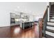 Modern kitchen flows into an eat-in dining area with a view of staircase with iron spindles at 1923 Skyfall Ne Cir, Atlanta, GA 30319