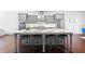 Kitchen with long island features seating for four, stainless appliances, and gray cabinetry at 1923 Skyfall Ne Cir, Atlanta, GA 30319