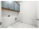 Convenient laundry room with tile flooring and overhead cabinets for extra storage space at 1923 Skyfall Ne Cir, Atlanta, GA 30319
