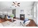 Bright living room with a modern fireplace, built-in shelves, and hardwood floors open to the kitchen at 1923 Skyfall Ne Cir, Atlanta, GA 30319