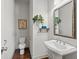 Cozy powder room with a pedestal sink, modern fixtures, and decorative wall accents at 1923 Skyfall Ne Cir, Atlanta, GA 30319