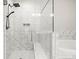 Detailed view of the shower featuring marble tiling, a seat, and glass door at 1923 Skyfall Ne Cir, Atlanta, GA 30319