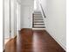 Hallway with hardwood floors leading to a staircase with wooden handrail at 1923 Skyfall Ne Cir, Atlanta, GA 30319