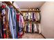 A walk-in closet with built-in racks and shelves, and hanging clothes at 2191 Spear Point Dr, Marietta, GA 30062