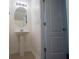 Powder room with pedestal sink, oval mirror, and simple lighting at 2326 Bigwood Trl, Atlanta, GA 30349